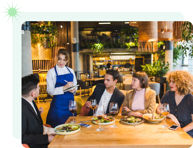 A diverse group of individuals gathered around a table, enjoying a meal together in a warm and inviting setting.