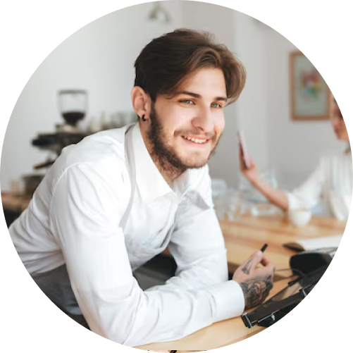 A man smiles while seated at a table with a woman, creating a warm and friendly atmosphere.